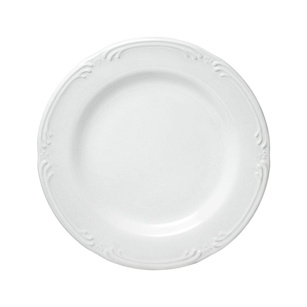 Dishwasher safe salad plate with a slice of cake on a rustic table.