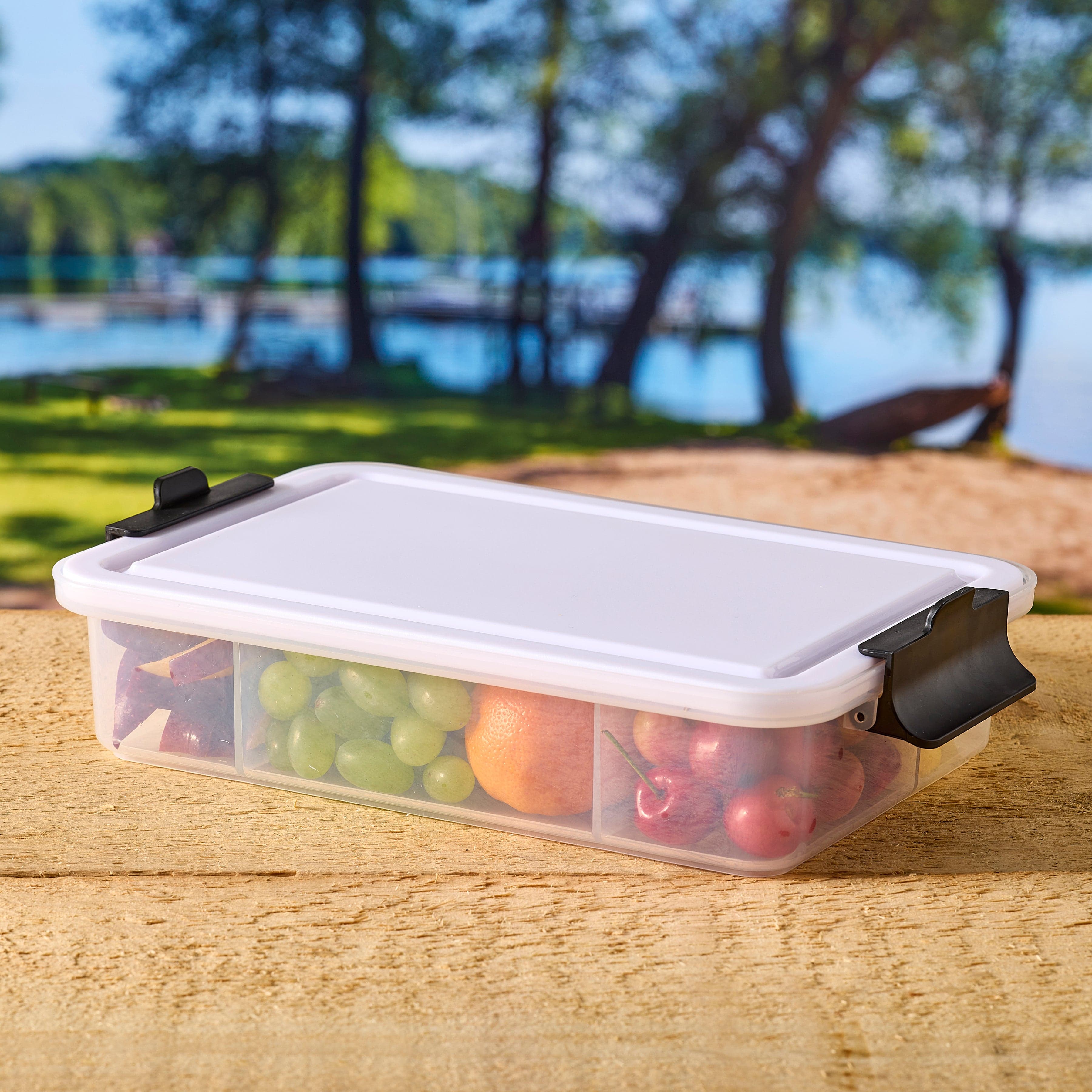 Reversible cutting board lid of Farberware snack box, showcasing its dual functionality.