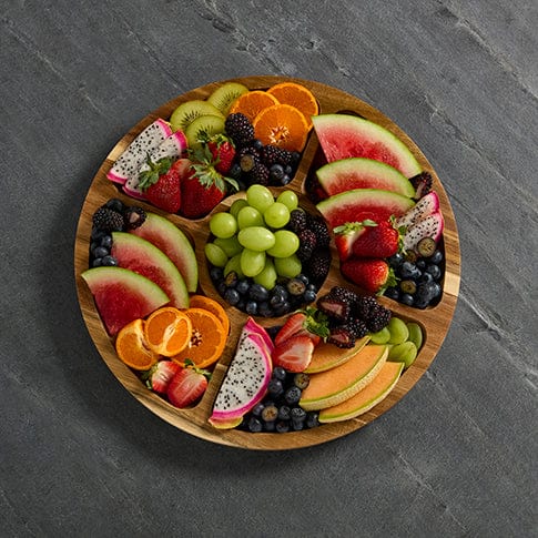 Versatile Culinary Board with clear lid showing arranged cheeses and fruits