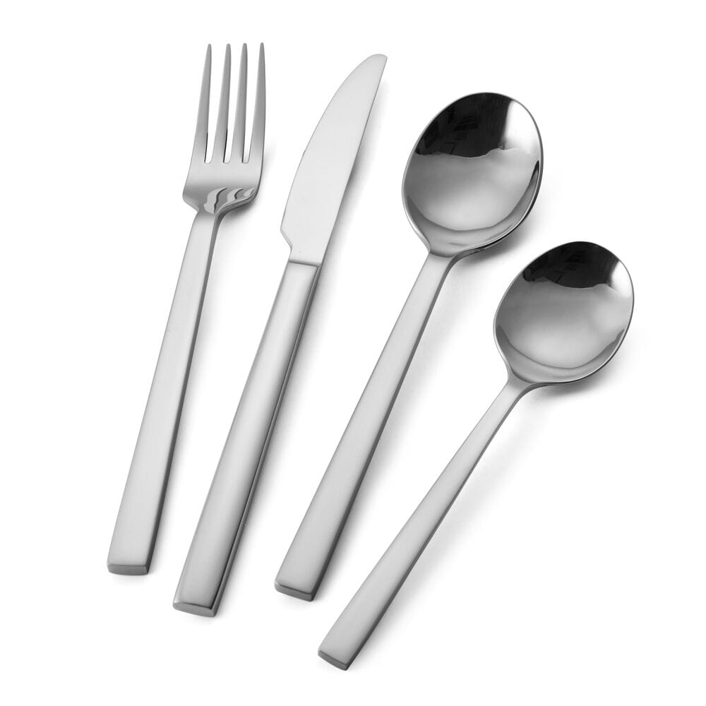 Close-up view of the stainless steel finish of the Paros flatware set against a vibrant table setting.