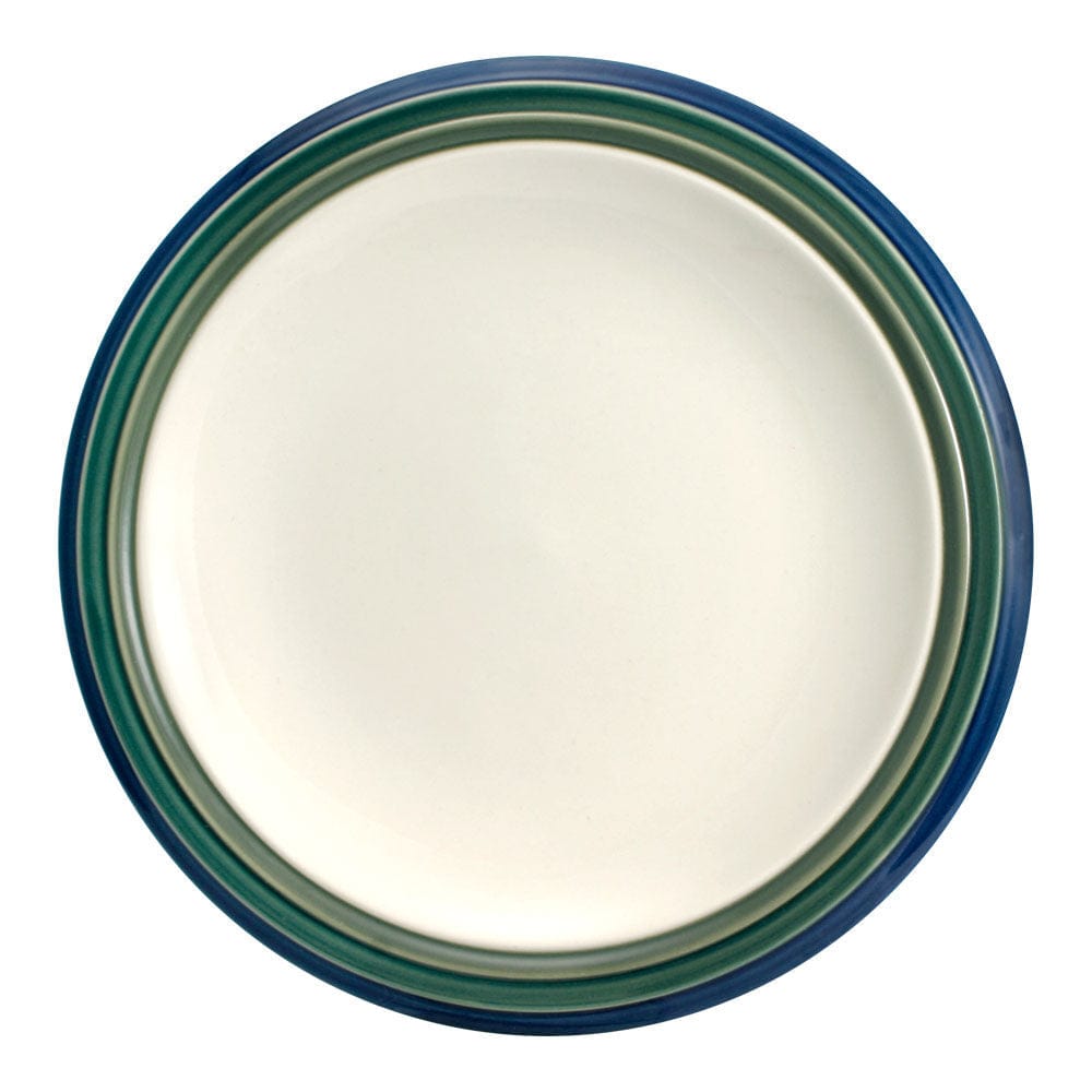 Set of four microwave safe dinner plates on a modern dining table, ready for serving.