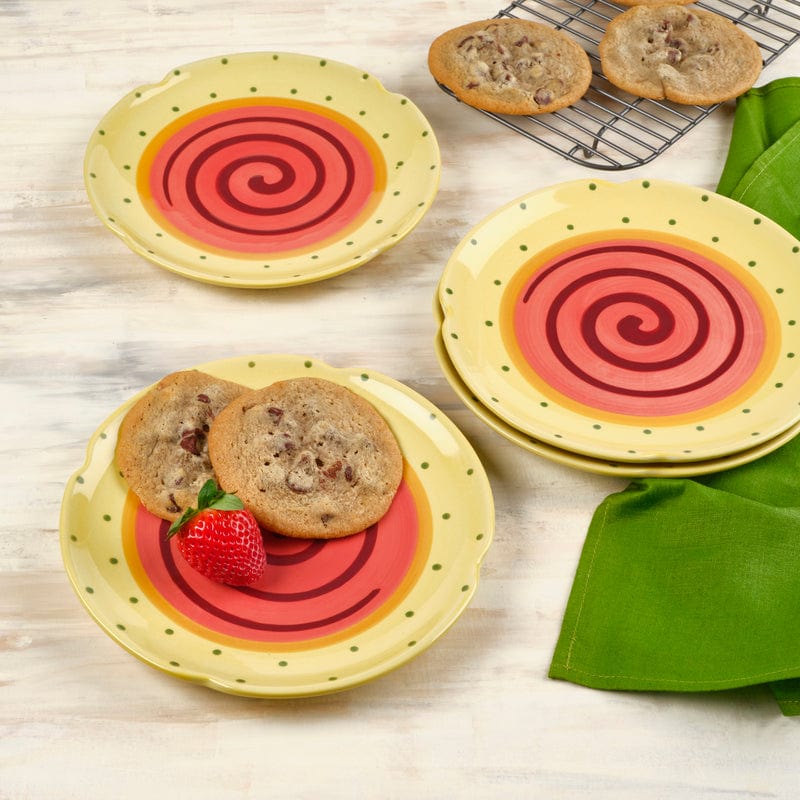 Set of three vibrant stoneware dessert plates arranged on a table, showcasing their cheerful appearance.