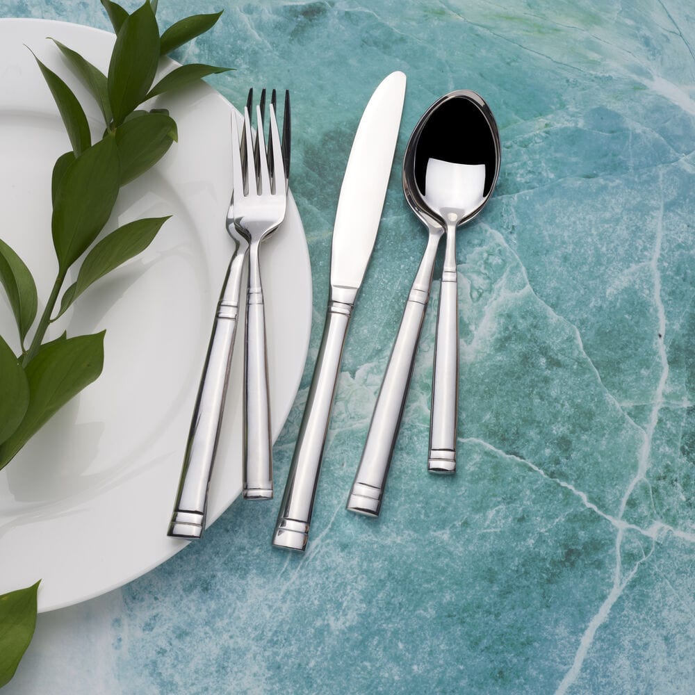 Elegant arrangement of Stephanie 20-piece stainless steel flatware set on a beautifully set dining table.