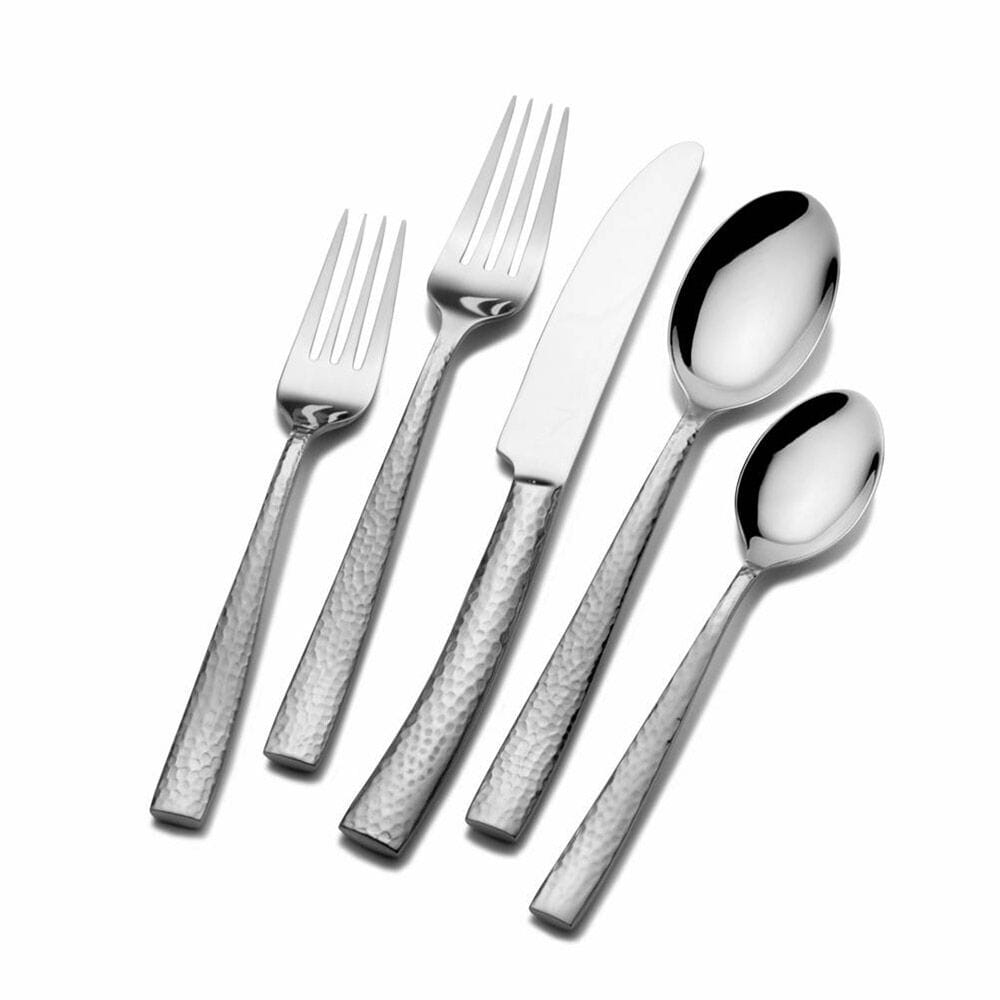 Flatware set for formal dining, styled with dinnerware and glasses