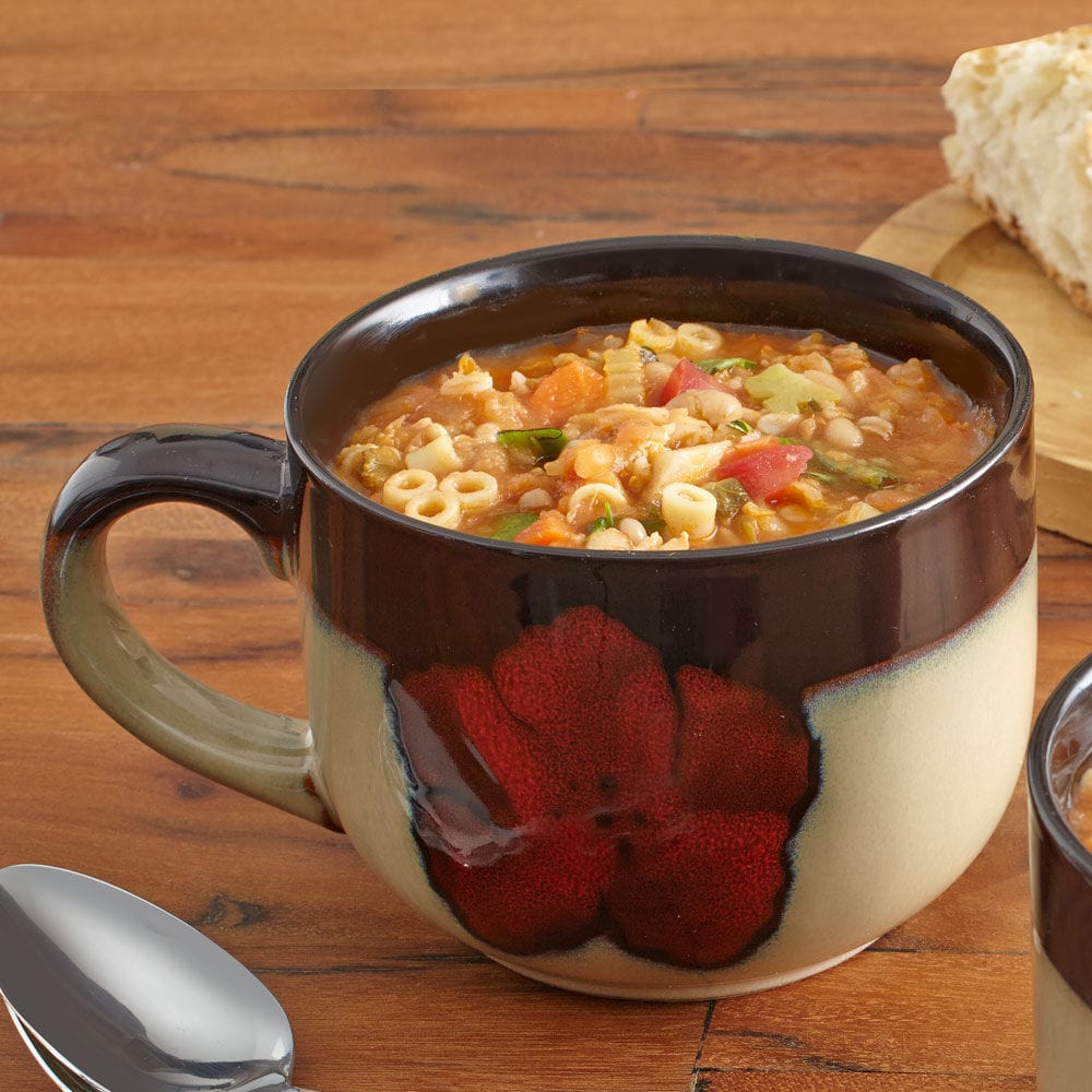 Close-up of the painted poppies design on the stoneware soup mug with handle