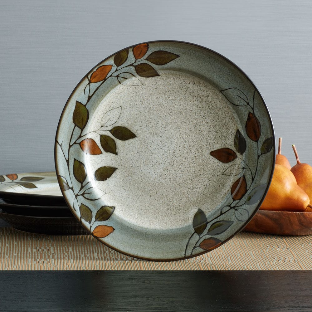 Close-up of rustic leaf patterned dinner plates showing reactive glaze finish