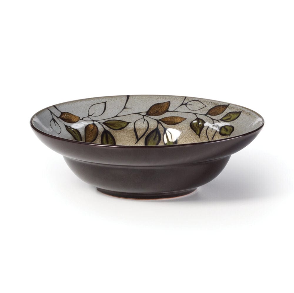 Side view of a rustic stoneware bowl filled with soup, showcasing unique pattern