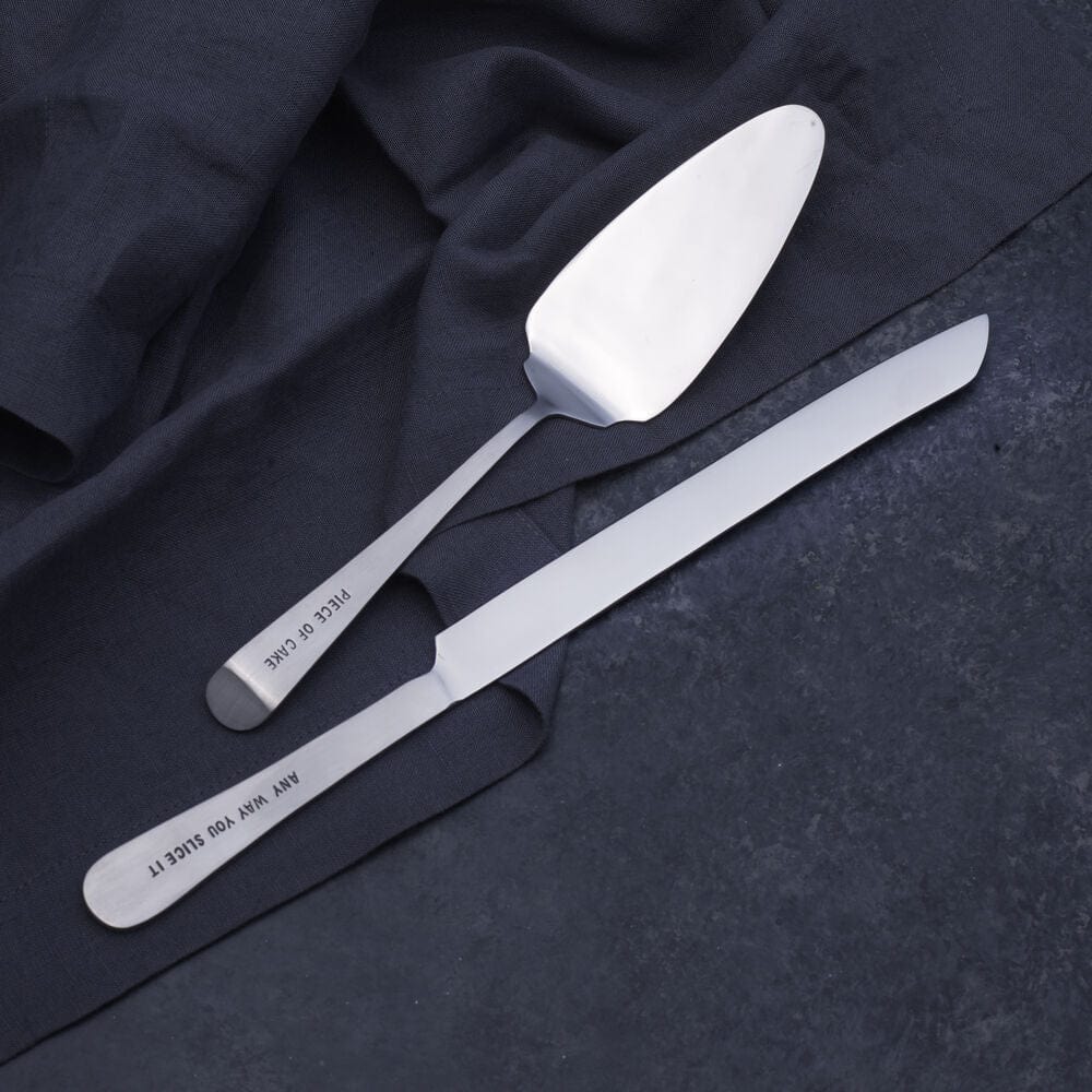 Close-up of stainless steel cake knife with engraved sentiment for dessert serving