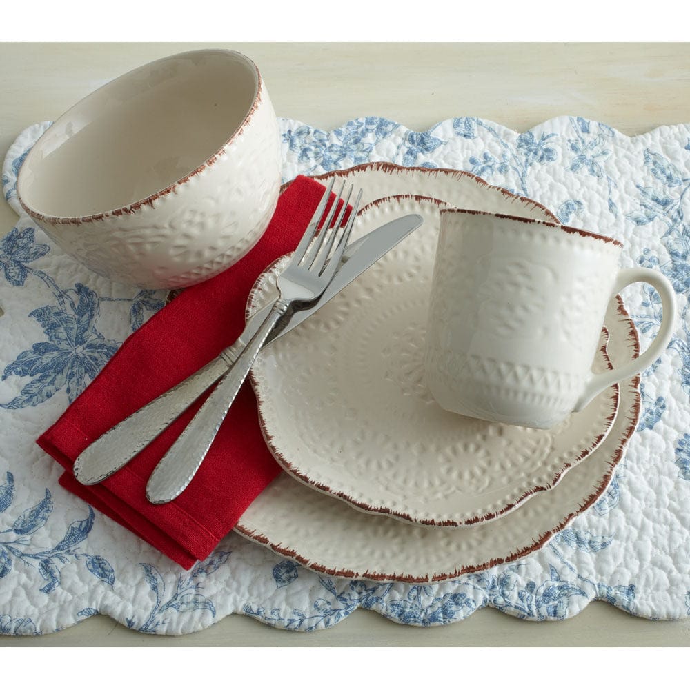 Chateau Elegance dinnerware set displayed on a beautifully set dining table, showcasing the stoneware dishes and mugs.