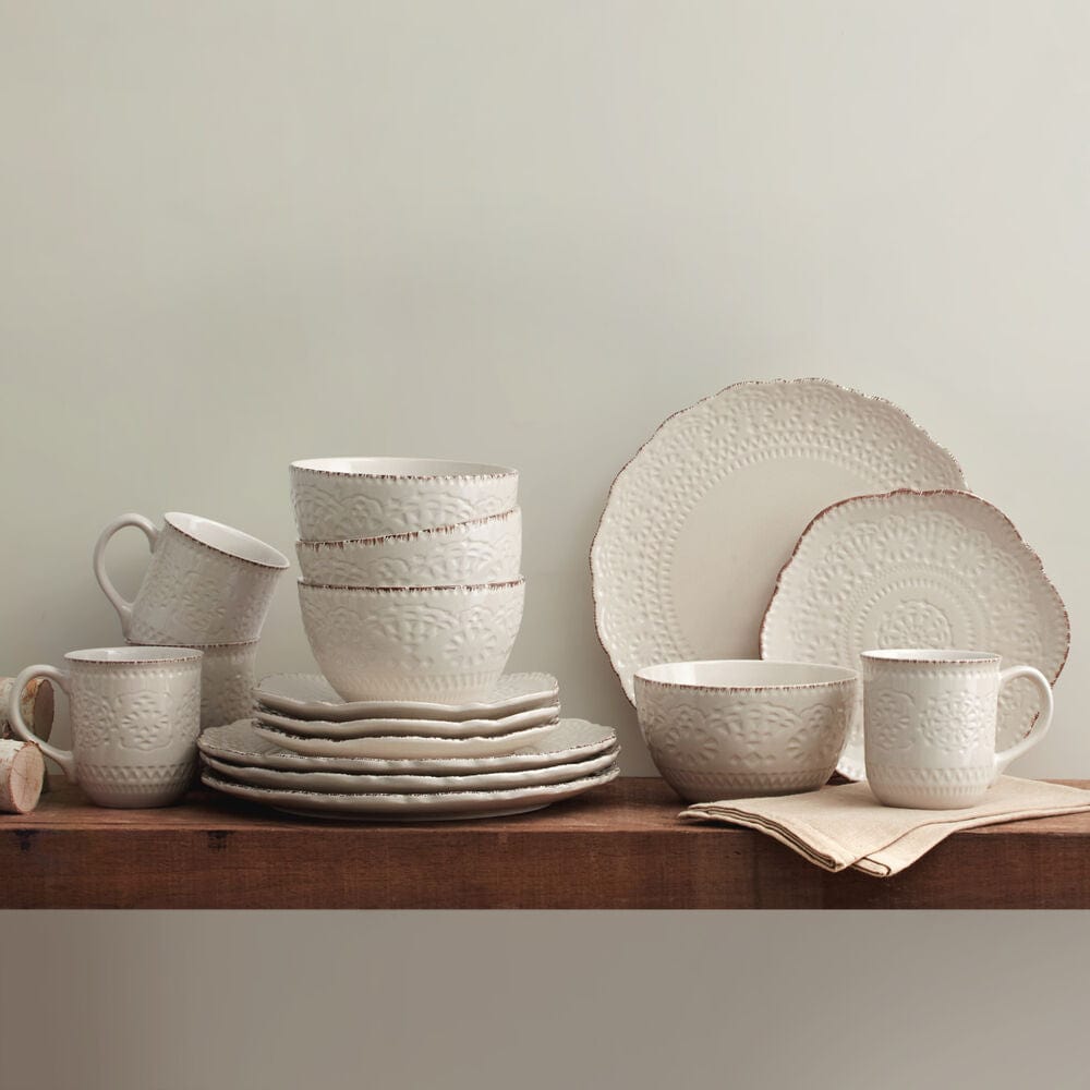 Chateau Elegance dinnerware set displayed on a beautifully set dining table, showcasing the stoneware dishes and mugs.