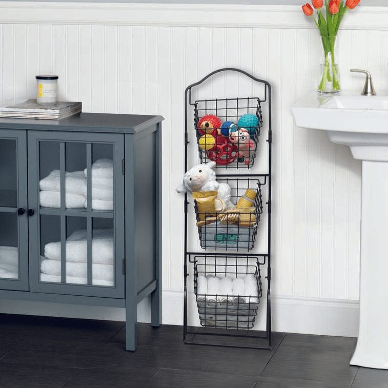 Angled front view of the 3-tier market basket storage rack styled in a bathroom