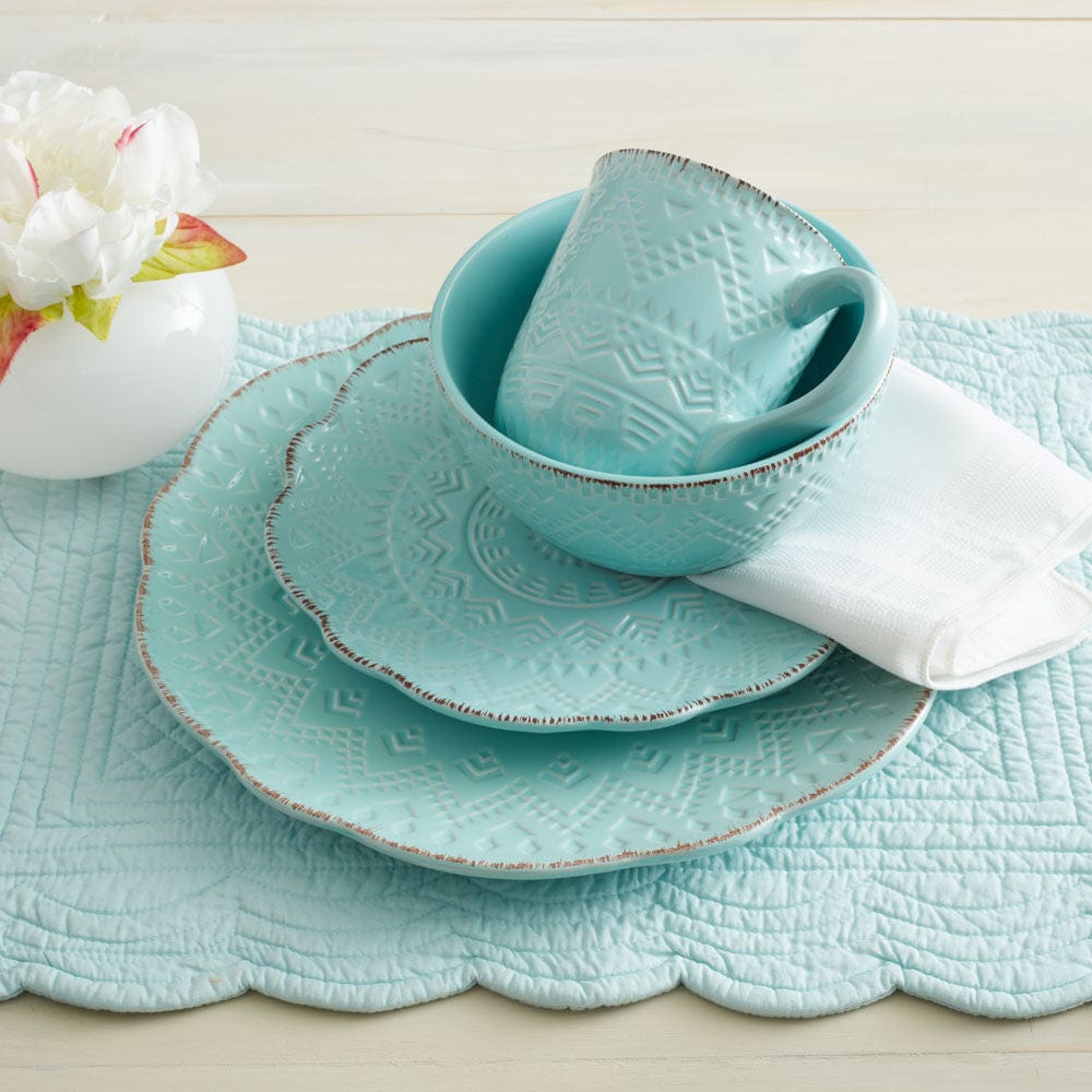 Close-up view of the teal stoneware cereal bowls and dinner plates.