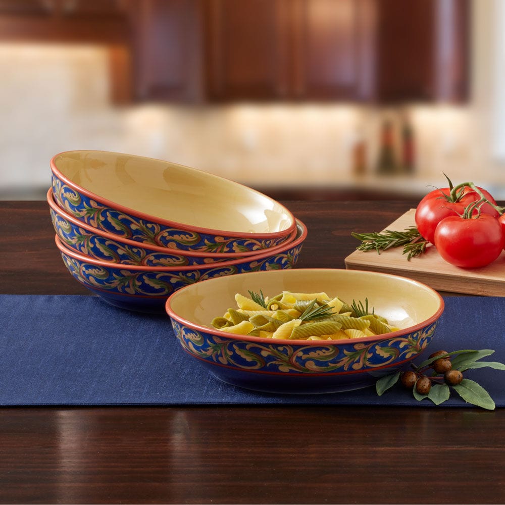 Top-down view of large ceramic pasta bowls with high sides filled with tomato spaghetti