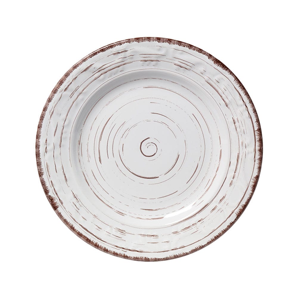 Elegant white stoneware salad plate on a dining table, ideal for serving salads.