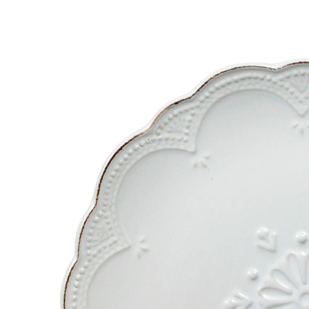 Close-up view of the elegant stoneware dinner set showcasing the intricate French lace design.