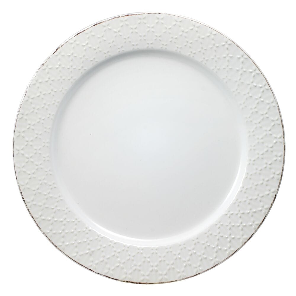 Close-up of white stoneware dinner plates with lace design for formal dining
