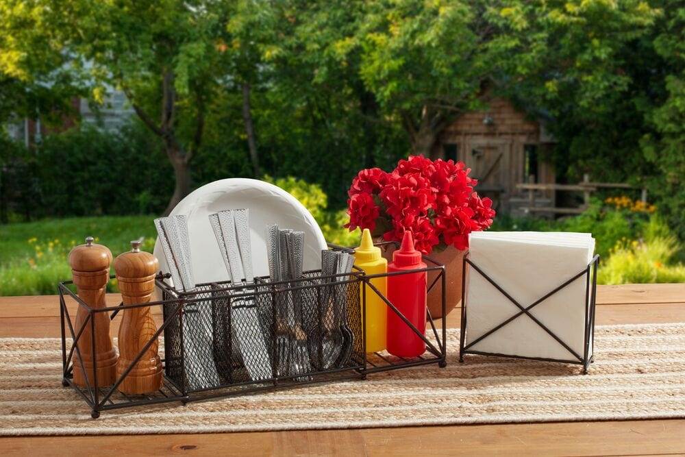 The Elegant Outdoor Buffet Caddy in use at a vibrant outdoor gathering, filled with serving essentials.