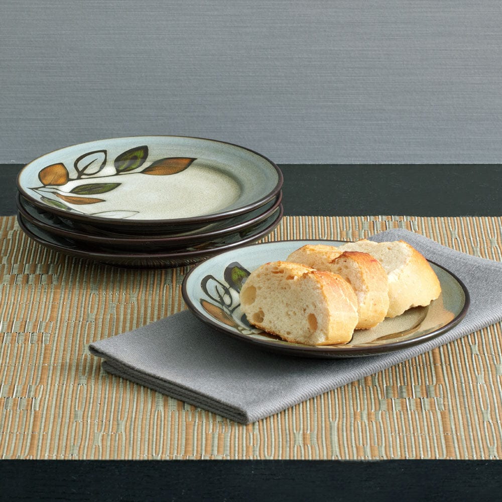 Close-up of handmade reactive glaze appetizer plates showcasing unique patterns and colors.