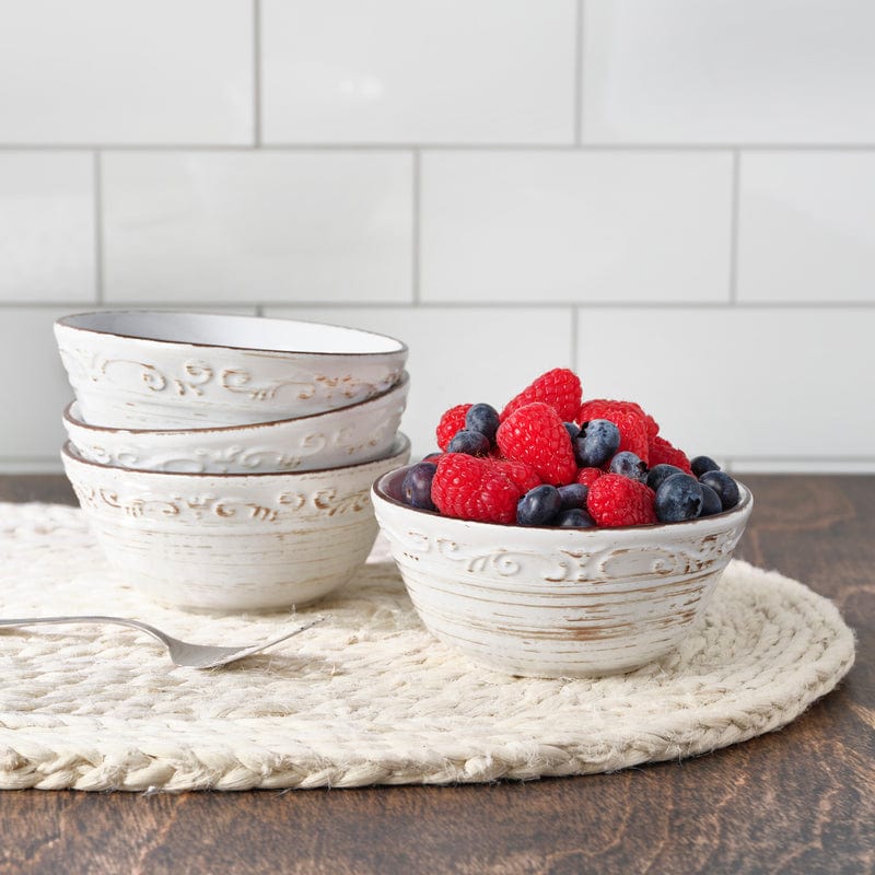 Close-up of Trellis White stoneware fruit bowls showcasing the scroll pattern