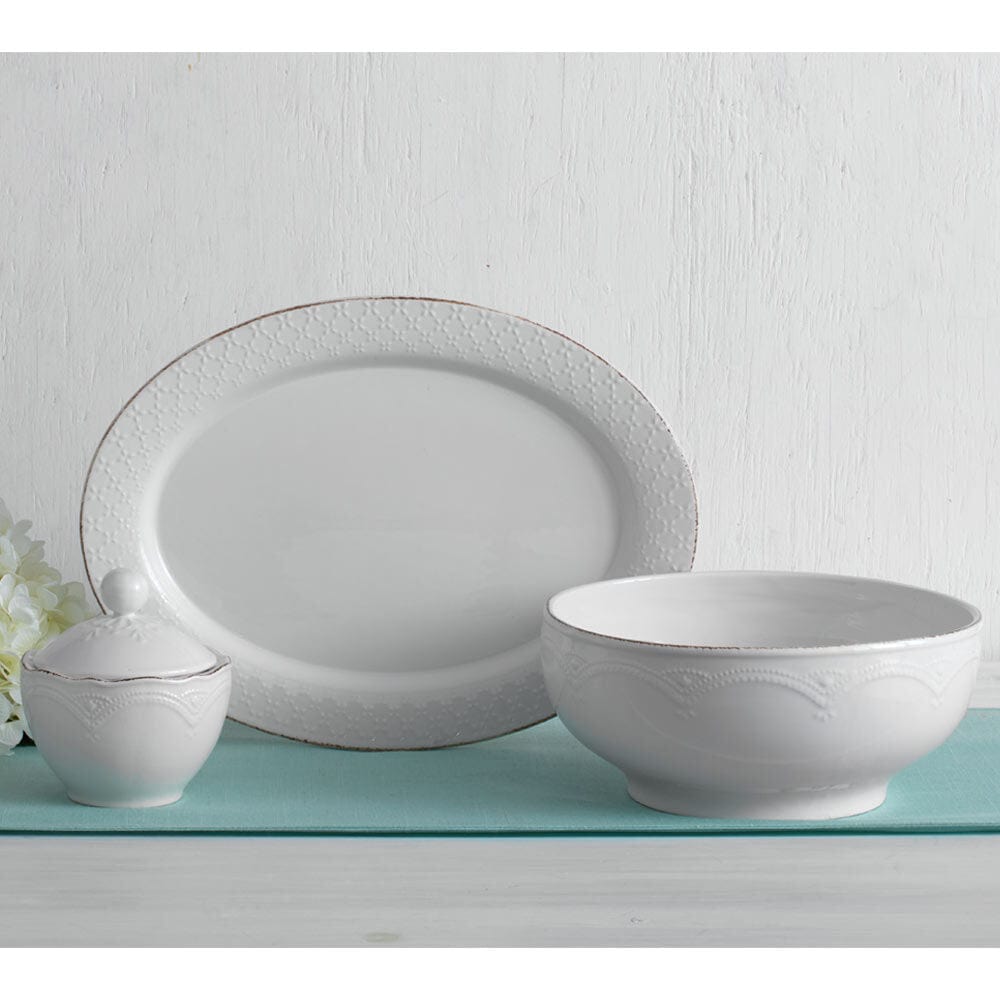 Microwave safe white serving bowl filled with a delicious salad, demonstrating its use during gatherings.