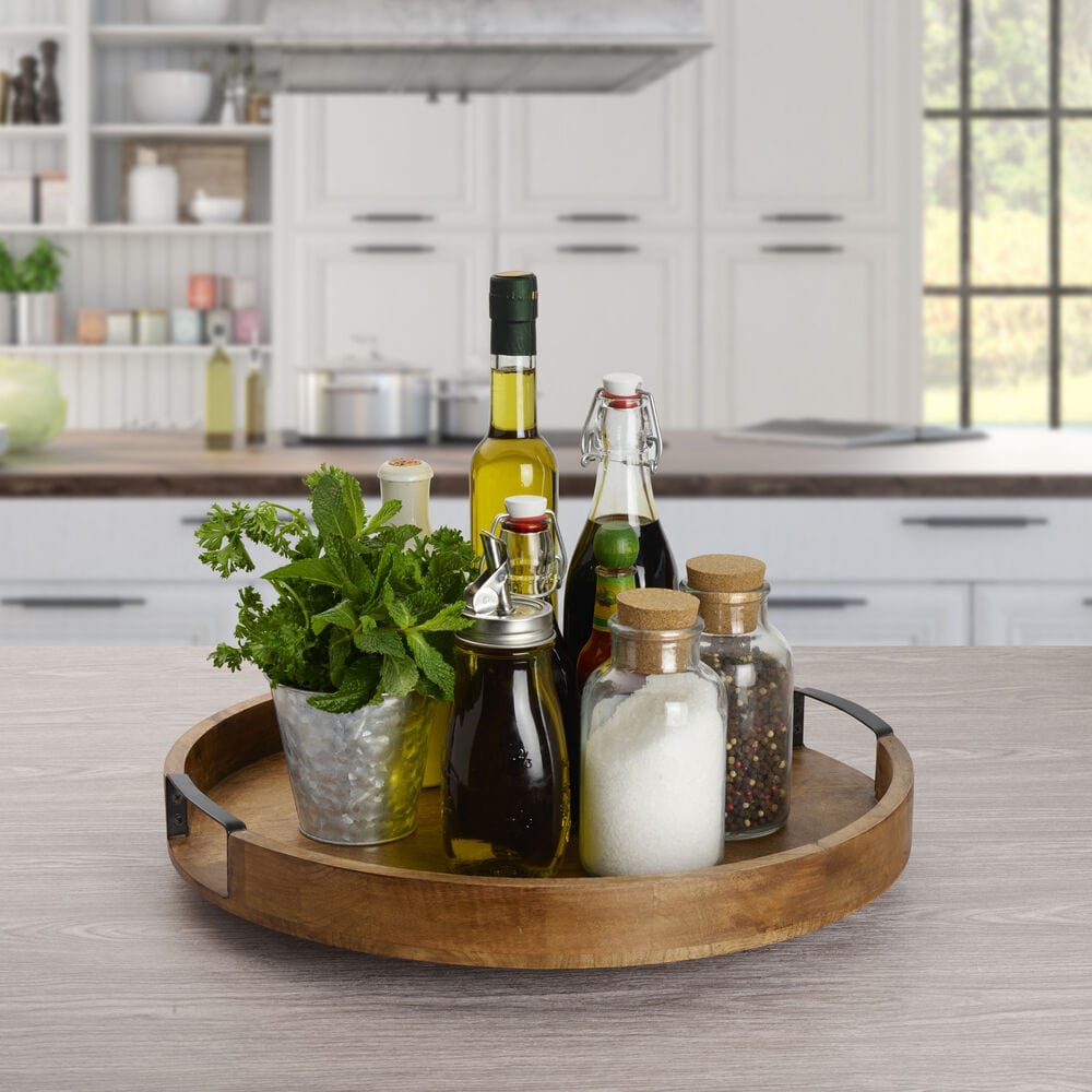Mango wood lazy susan with wrought iron handles on outdoor table, ideal for outdoor entertaining