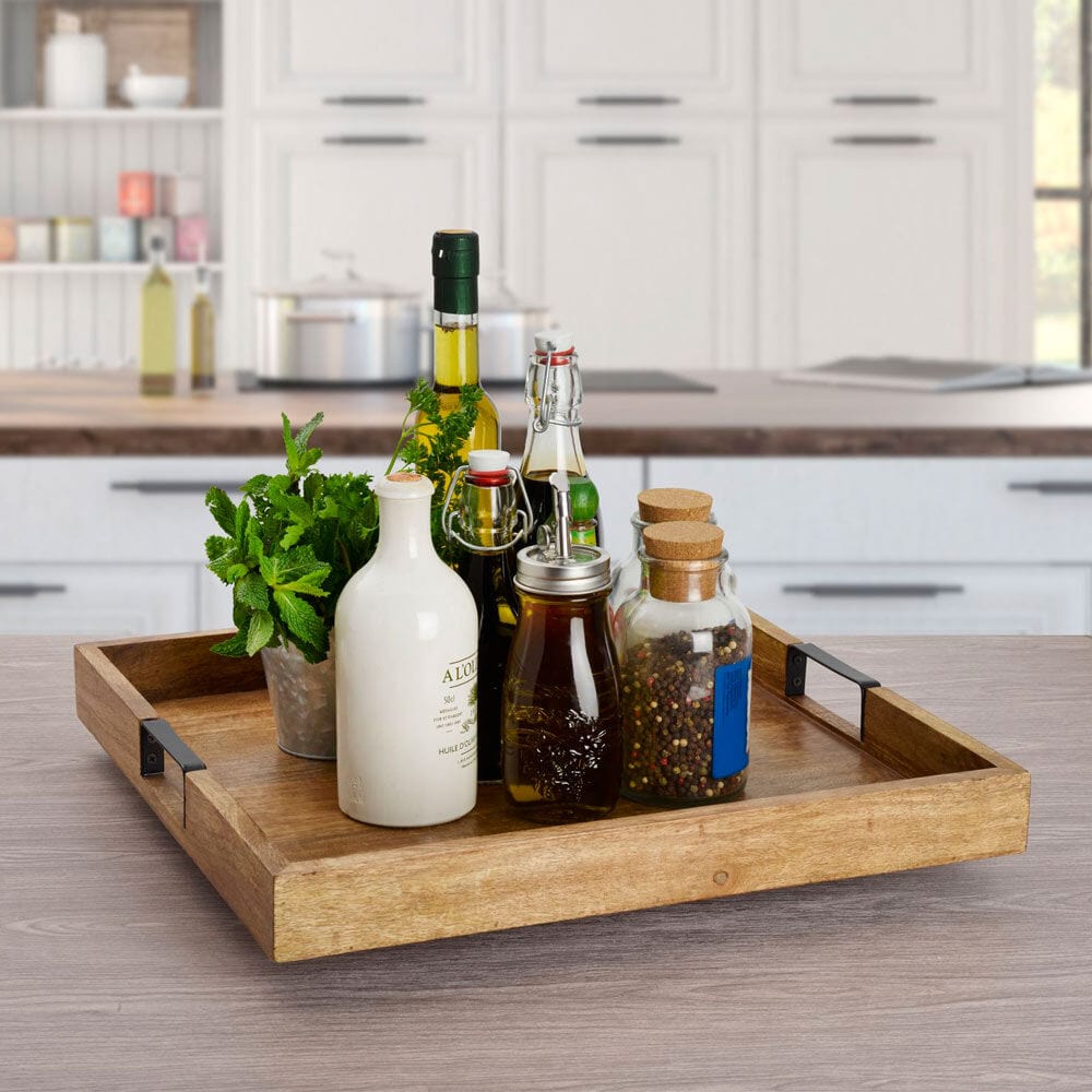 Large wooden Lazy Susan for parties with a square design and iron handles on a dining table