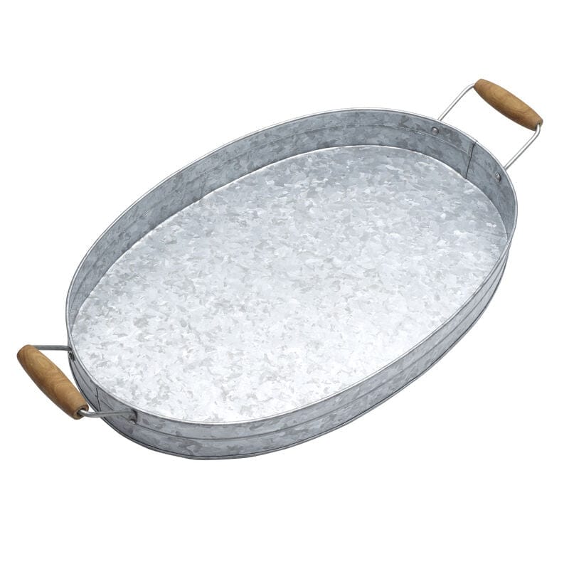 Decorative oval tray on a coffee table with candles and flowers