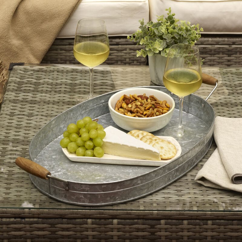 Galvanized oval serving tray with wooden handles, close-up view
