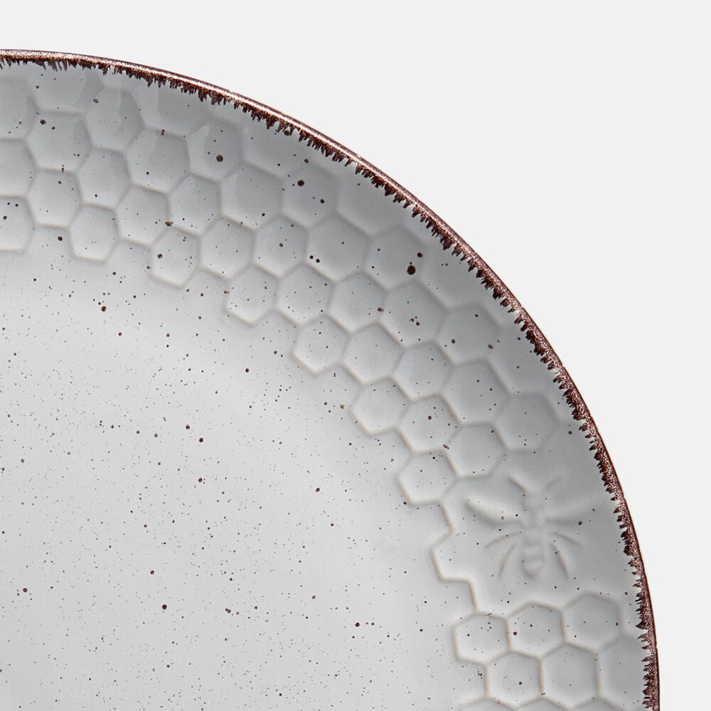 Set of stoneware dishes including dinner plates, bowls, and mugs arranged for a meal