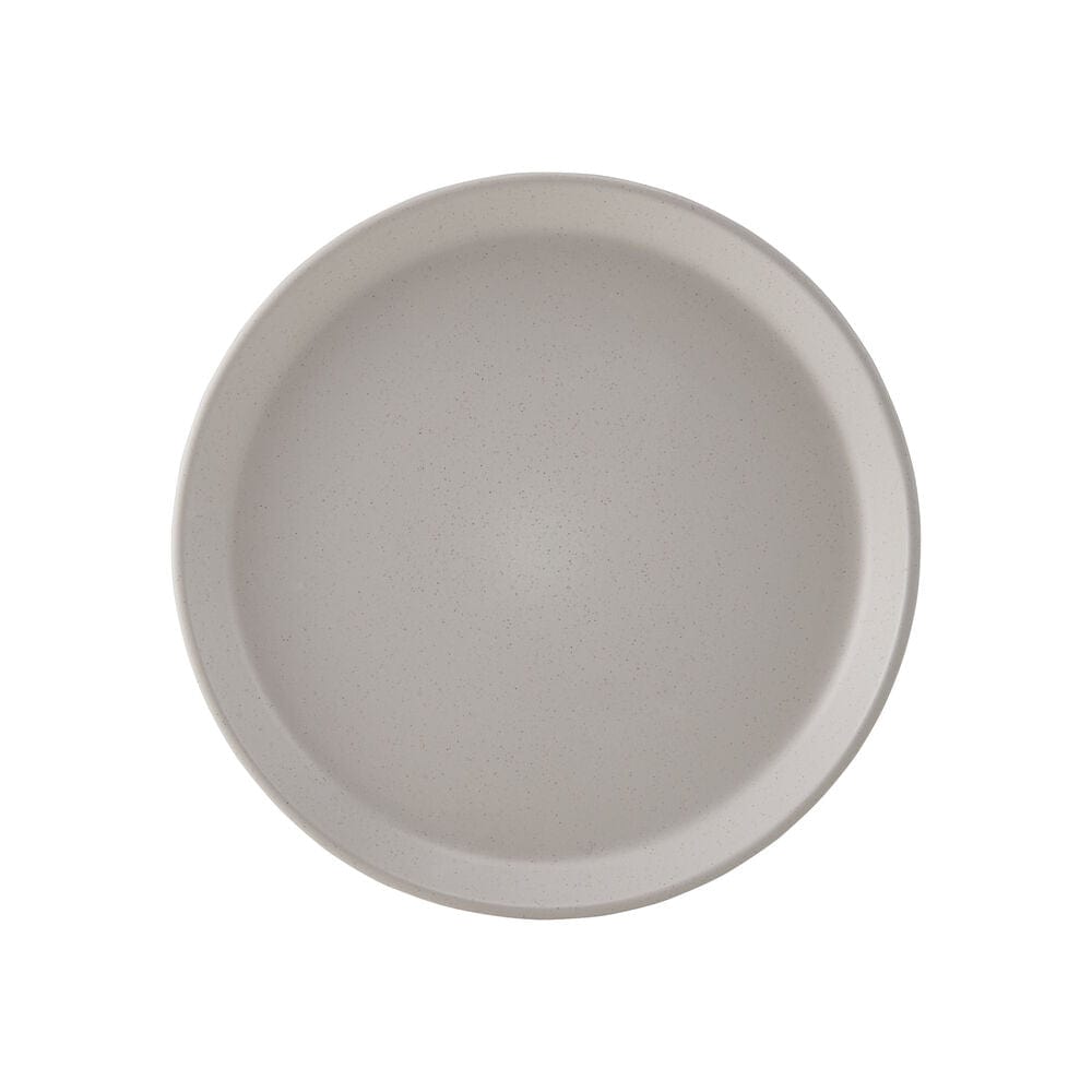 Elegant beige stoneware dinner plates set on a dining table, showcasing the unique coupe shape.