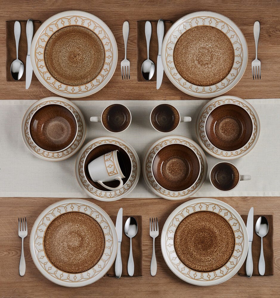 Stacked set of dinnerware with mugs and bowls showcasing reactive glaze finish