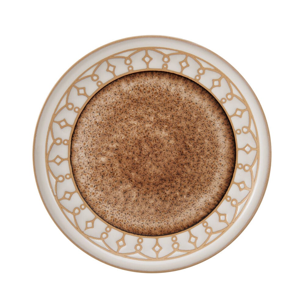 Close-up of the beige speckled stoneware dinner plate with artistic glaze