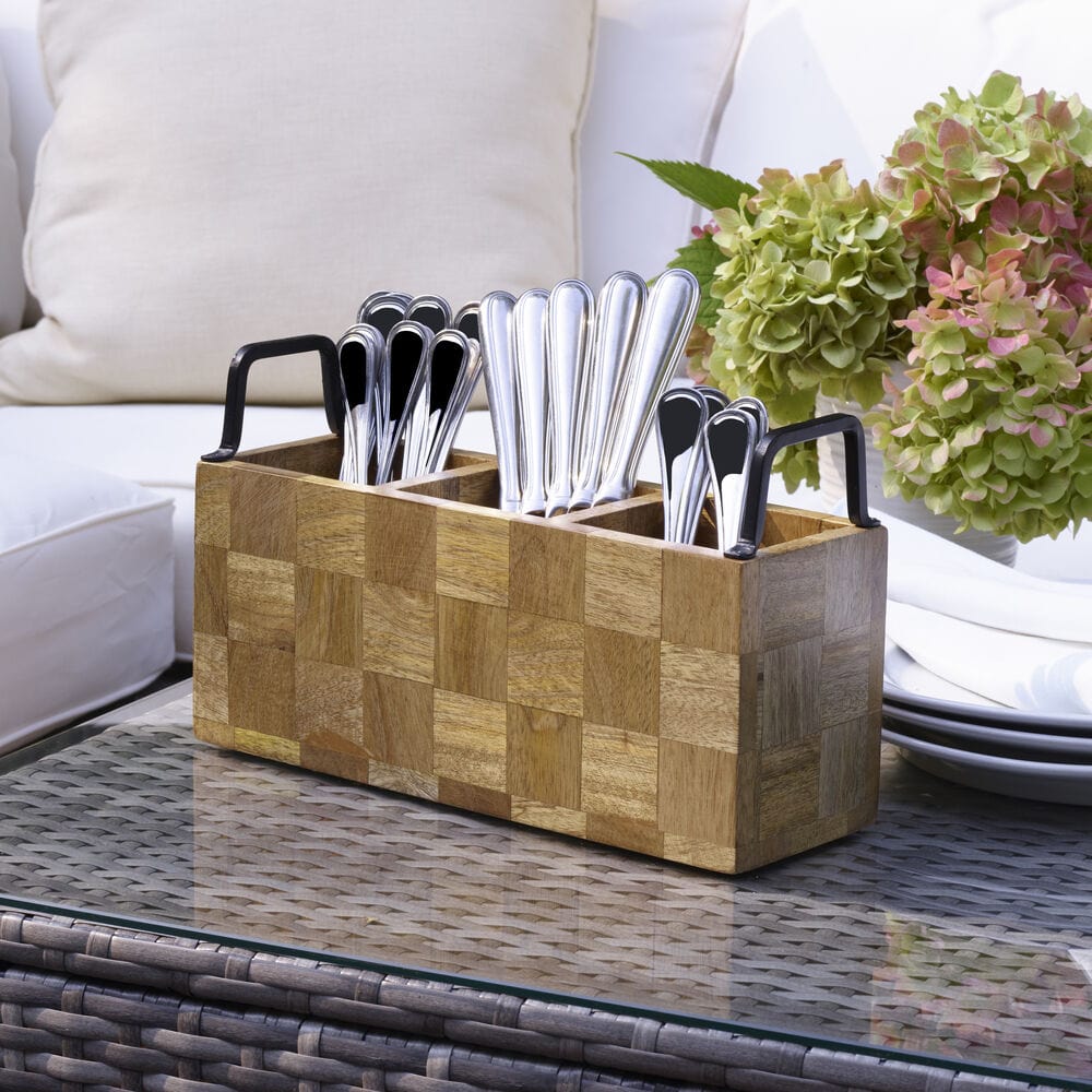 Flatware caddy in use during a dinner party, holding forks, knives, and spoons