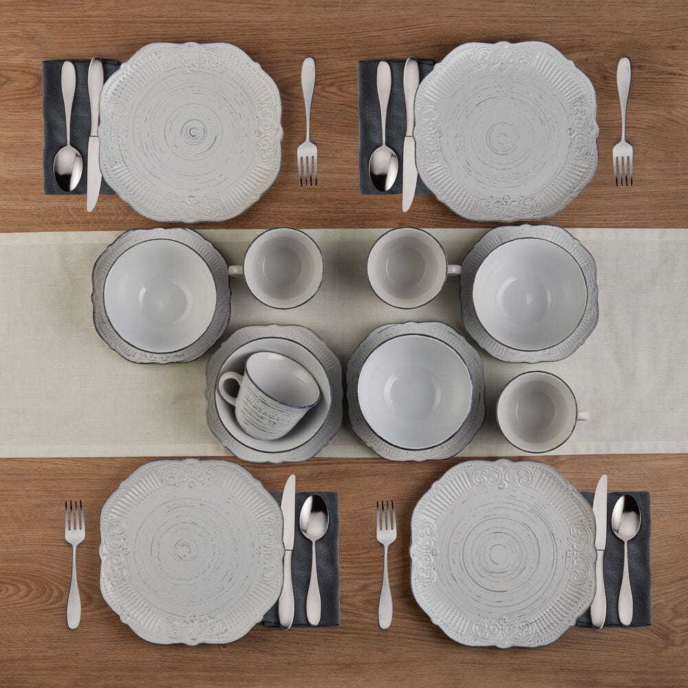 Rustic Charm stoneware dinnerware set displaying the unique scalloped edge design on a dining table.