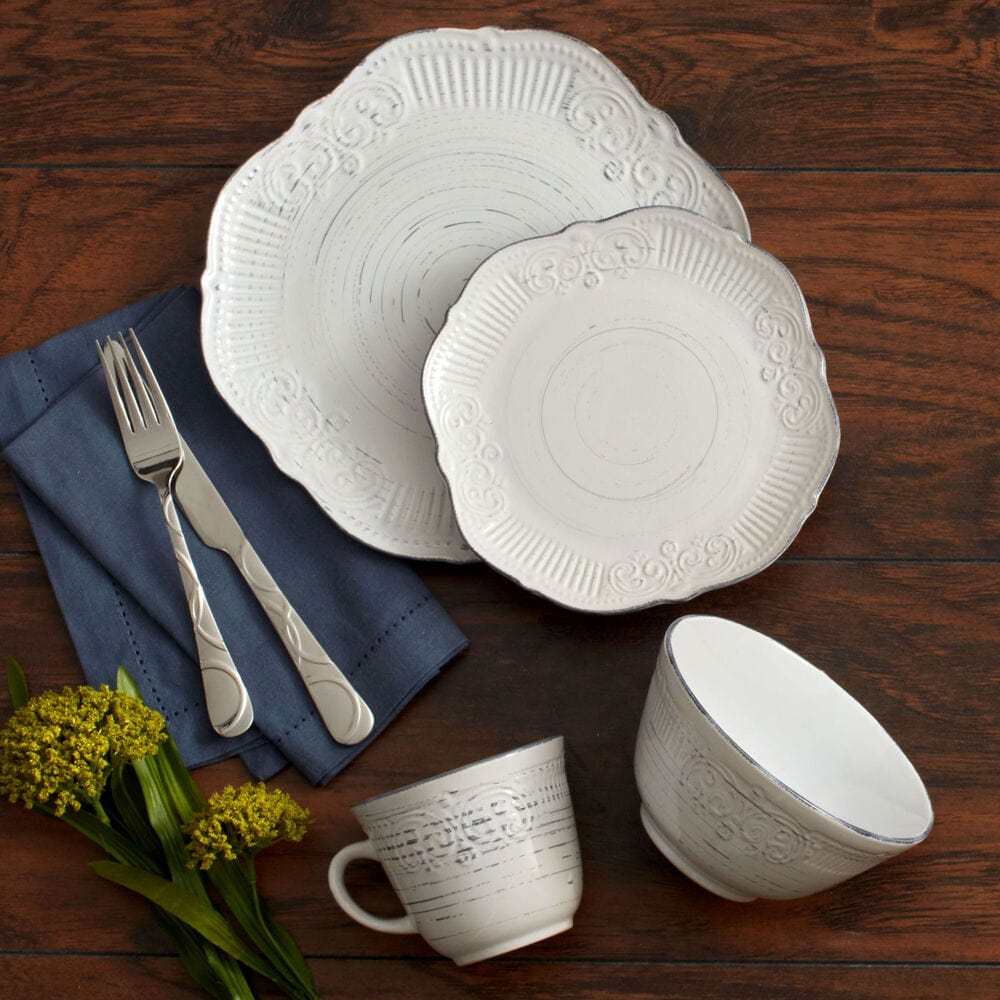Rustic Charm dinnerware set arranged for a festive gathering, featuring plates, bowls, and mugs.