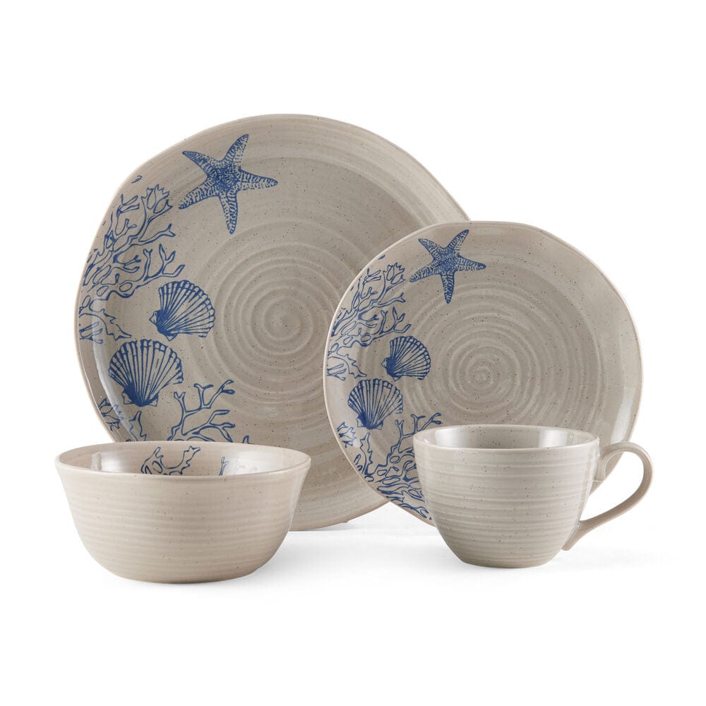 Set of 4 mugs and plates from the rustic dinnerware set with ocean-inspired pattern, arranged on a wooden table