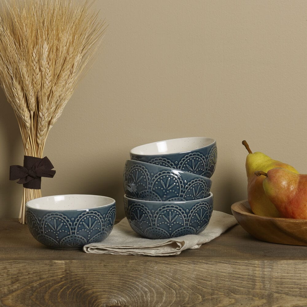 Close-up of handcrafted blue decorative bowls for dining filled with fresh fruits.
