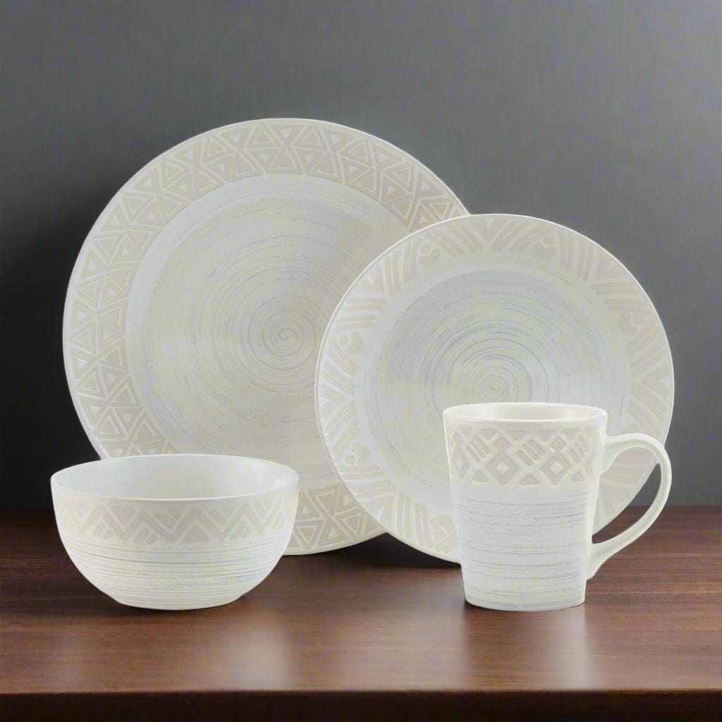 Vera dinnerware set for 4, showing dinner plates and mugs on a modern table