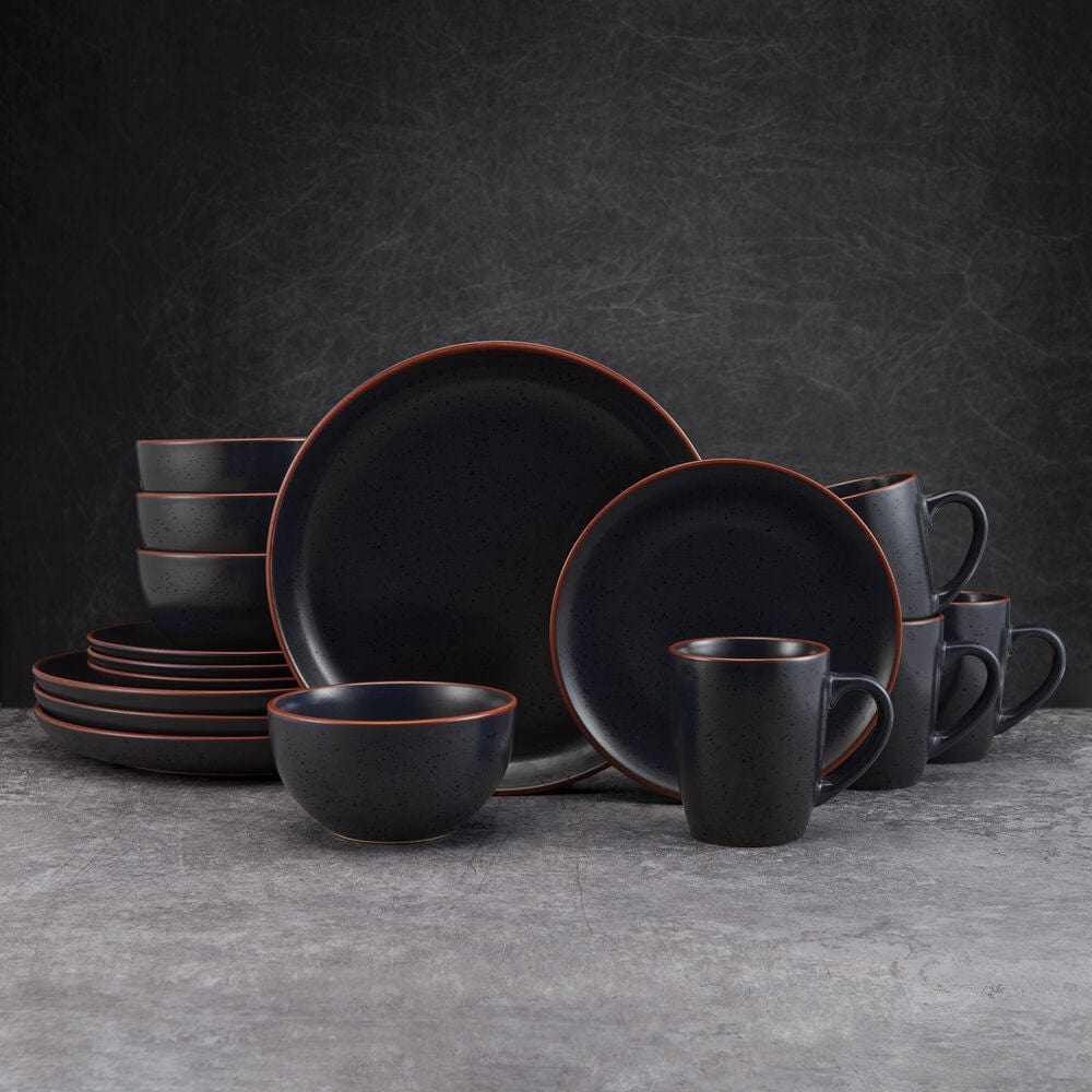 Hunter Black dinnerware set displayed on a dining table, showcasing its modern design and glossy speckles.