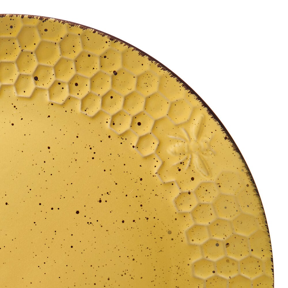 Sunny Honeycomb dinnerware set displayed on a dining table, showcasing dinner plates and bowls.