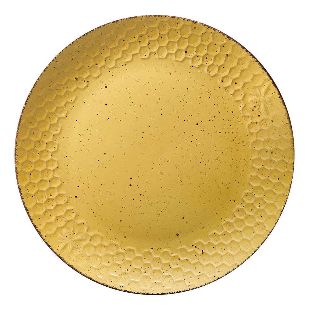 Sunny Honeycomb dinnerware set displayed on a dining table, showcasing dinner plates and bowls.