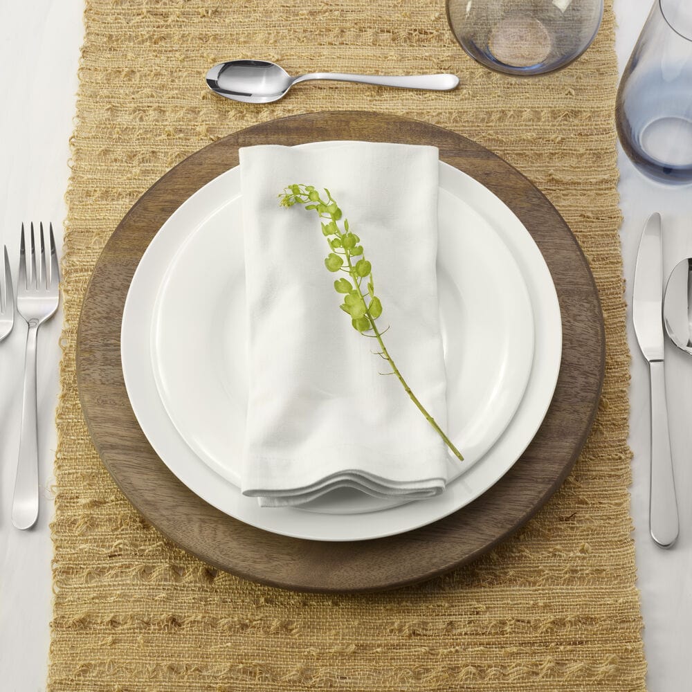 Stacked wooden charger plates showing their durable, rustic design