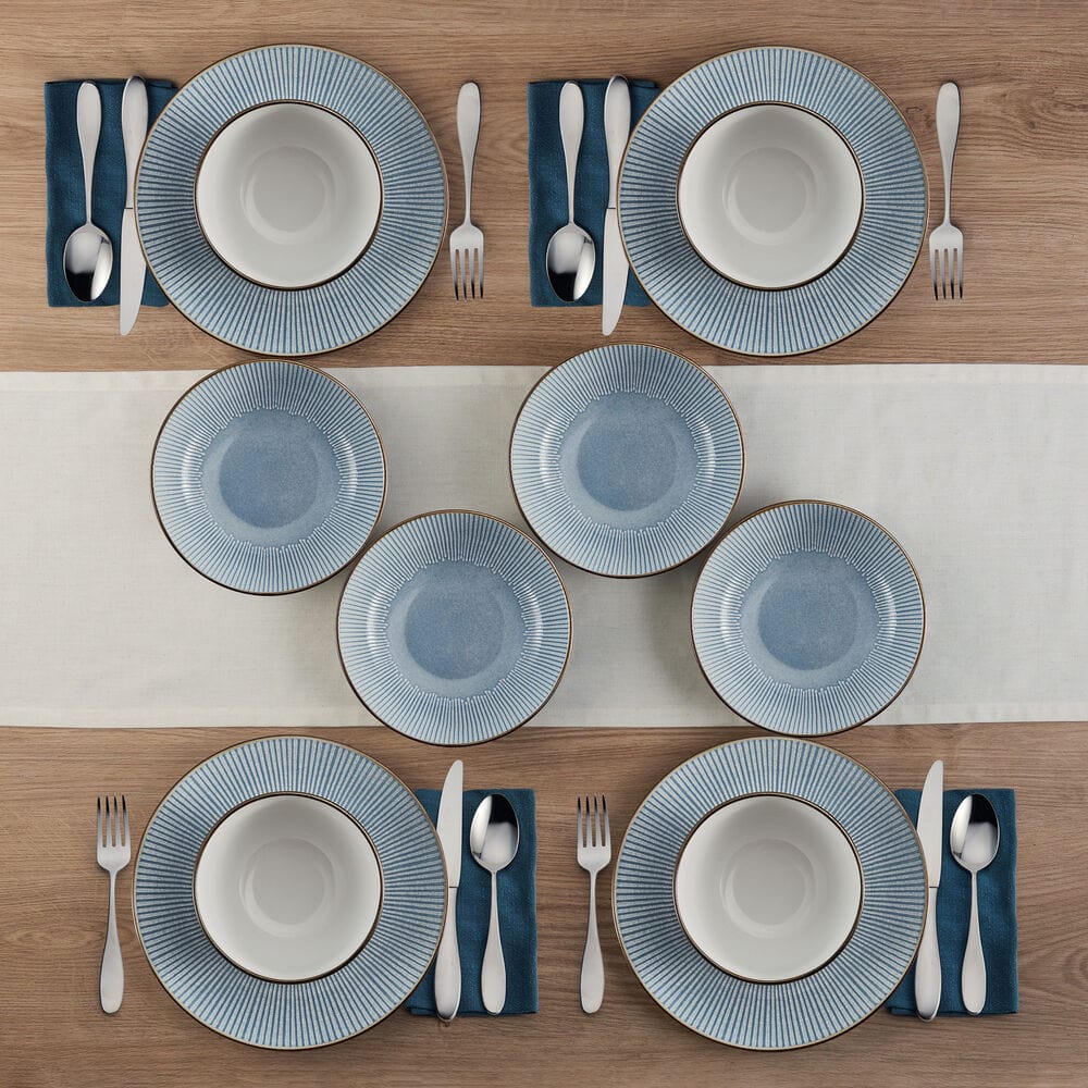 Close-up of embossed blue dinner plates with metallic rim detail