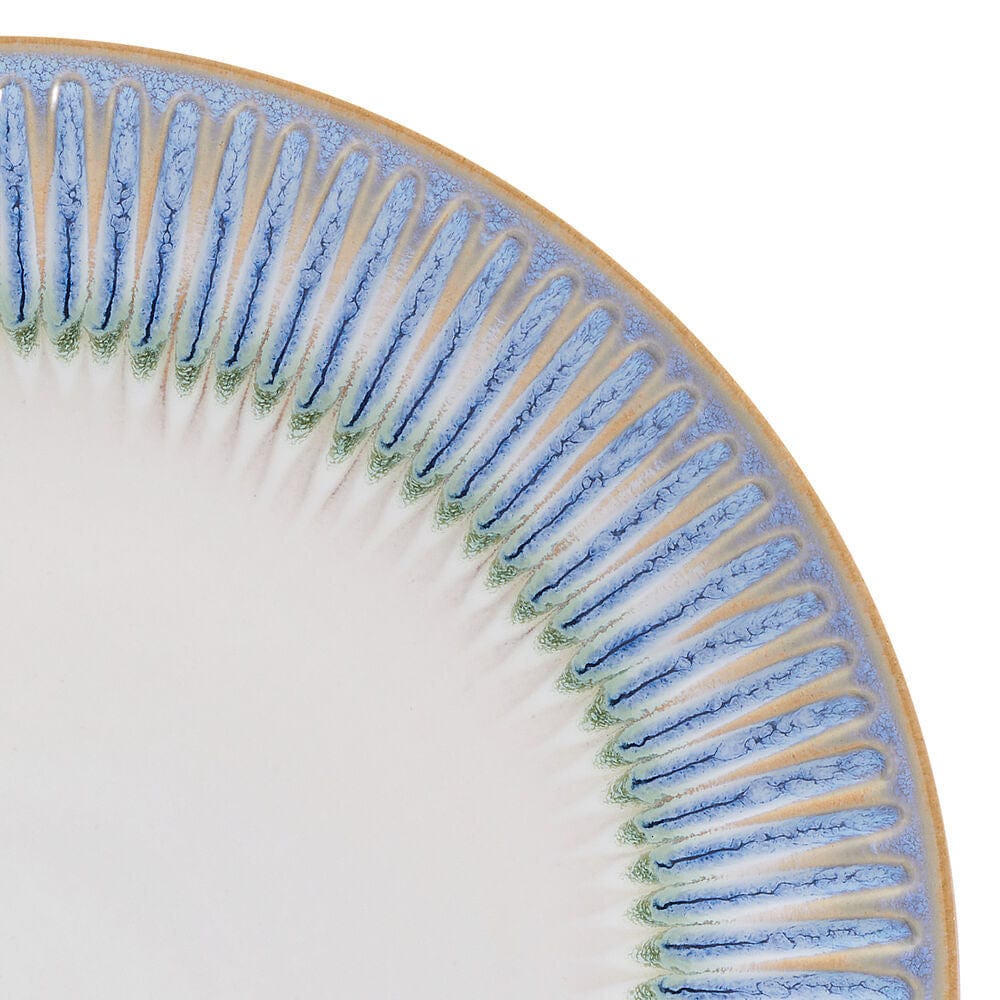 Set of Hensley Blue stoneware dinner plates, salad plates, and bowls on a dinner table