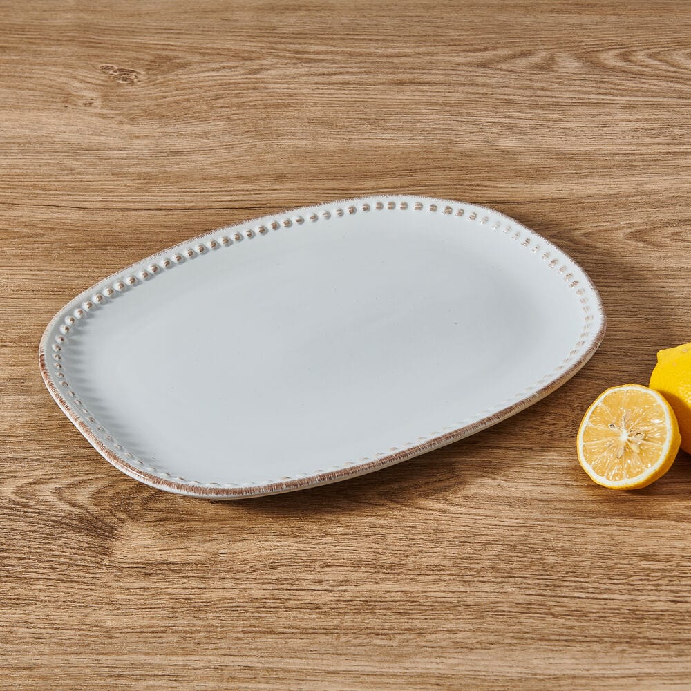 Close-up of the rustic Canyon Bead ceramic platter showing beaded rim and textured surface