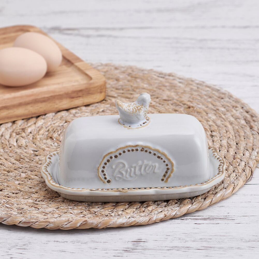 Rustic hen butter dish with lid showcasing scalloped edges and embossed design.