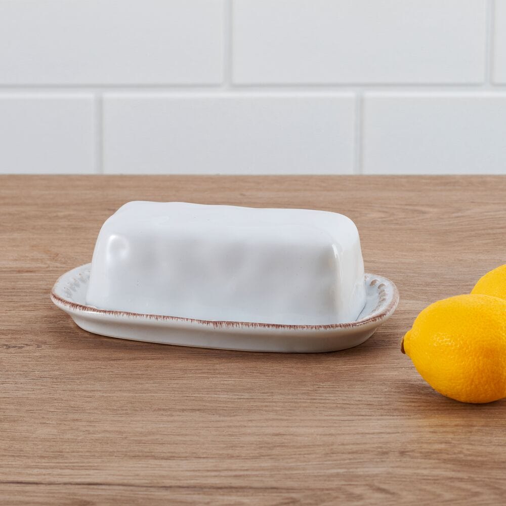 Side view of large ceramic butter dish with beaded rim and dents