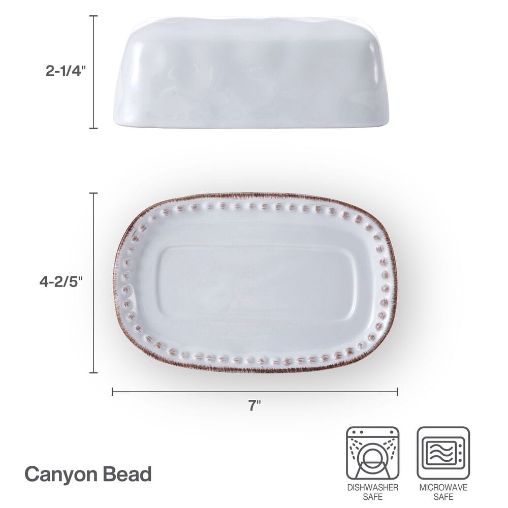 Close-up of beaded band on stoneware butter dish with dents