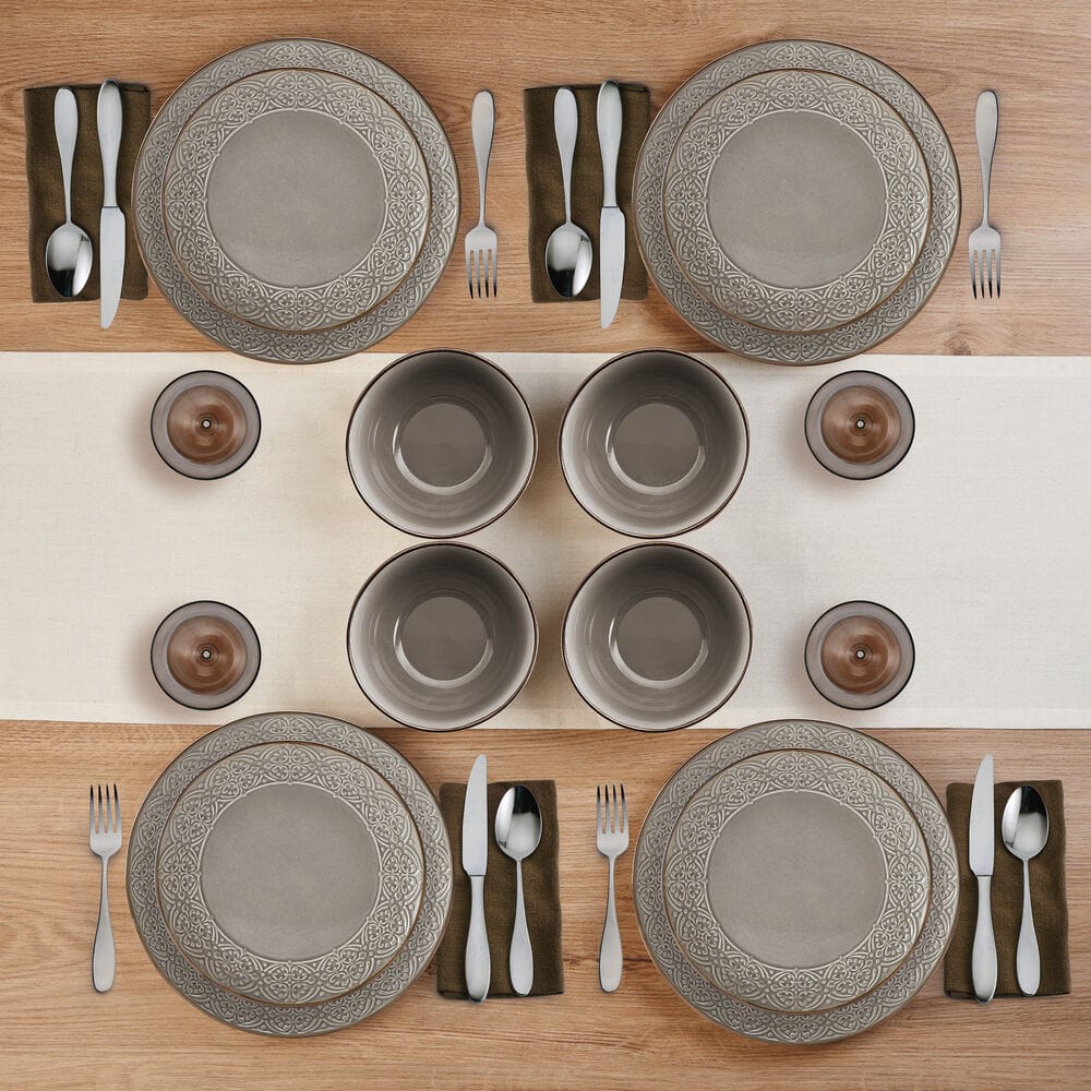 Emma 12-piece stoneware dinnerware set with embossed rims on a modern dining table