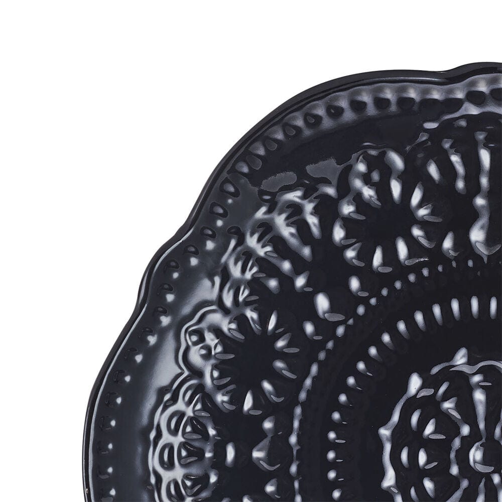 Modern dining table setup with black dinnerware set for four